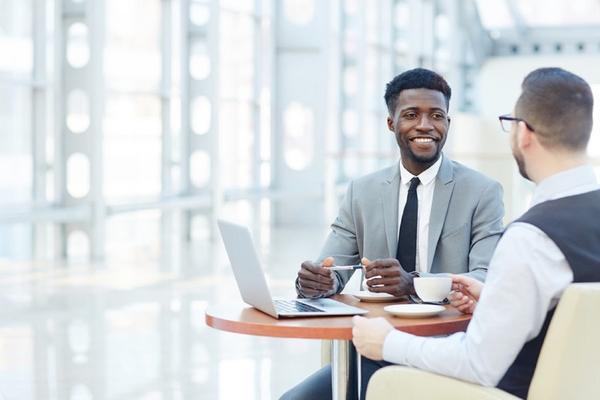 two young men meeting seated